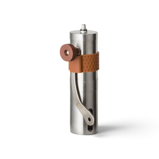 Adversary Force Helikon stainless steel manual coffee grinder with brown silicone grip and ceramic burr mechanism.